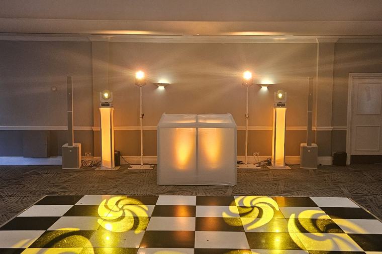 DJ booth and a black and white chequered dance floor with gobos at the DoubleTree in Borehamwood