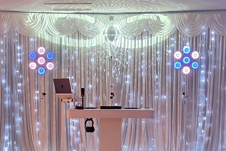 DJ booth against a white starlight backdrop at Maidens Barn