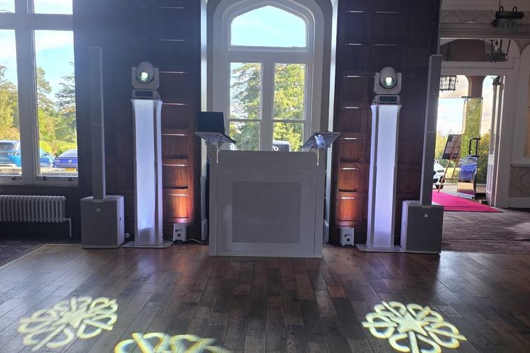 DJ booth in the panelled room at Shendish Manor, with patterned lighting across the wooden dance floor